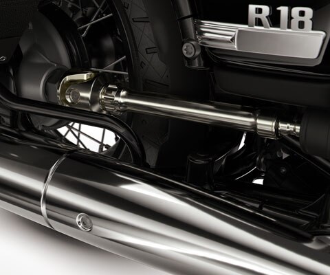 We see the round exhaust pipe, the open drive shaft, and the double cradle frame.