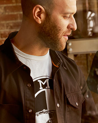 In the shot a man wears the white Dealer shirt for men.