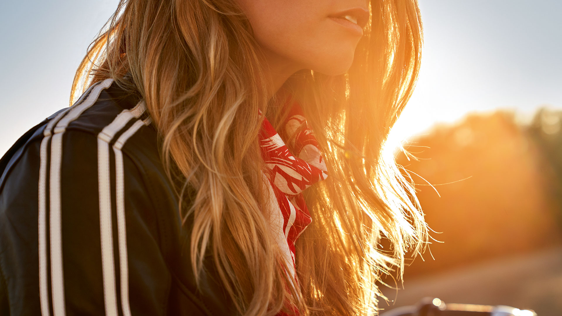 The close-up shows the Berlin Built bandanna worn by a woman in the sunshine.